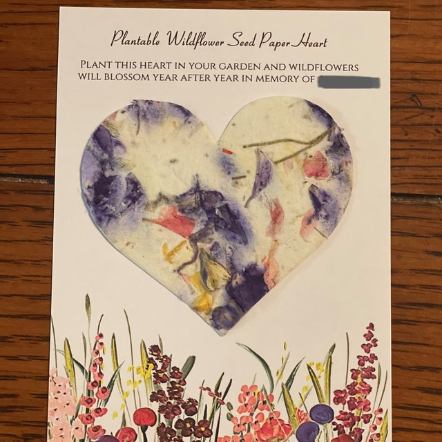 Seed paper heart shape attached to a memorial card.