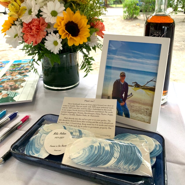 Seed paper circle shape on celebration of life table display memorializing Mike